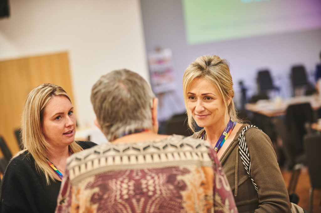 Three attendees in conversation