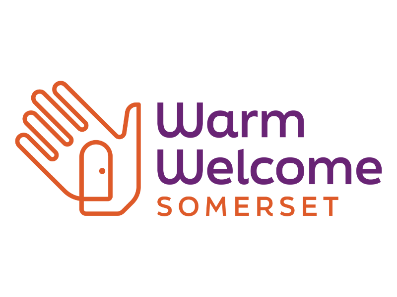 Warm Welcome Somerset logo: purple and orange text, with a graphic of an open hand