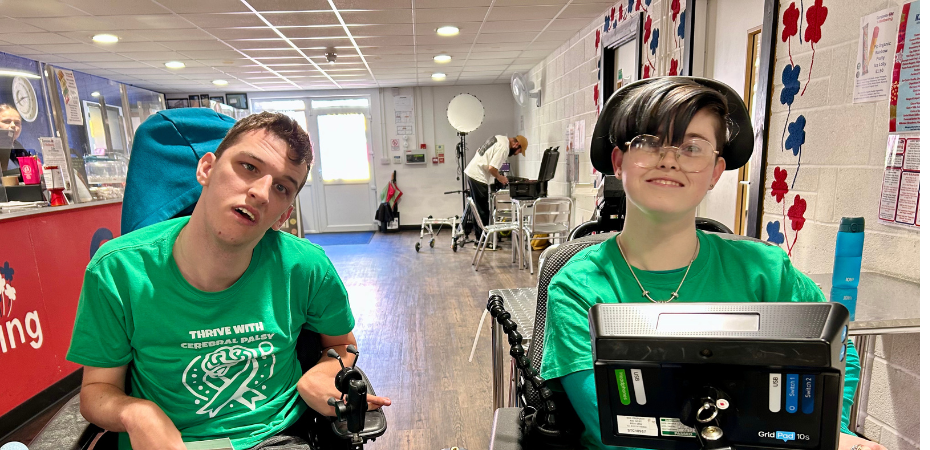 Photograph of volunteers Ryley (left) and Cole (right). They are wearing matching green t-shirts and looking at the camera.