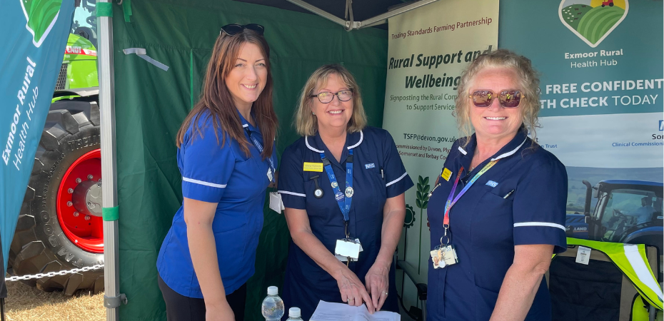 A photo of three of the nurses from the Exmoor Rural Health Hub, stood together at a promotional stall for the hub. They are smiling at the camera.