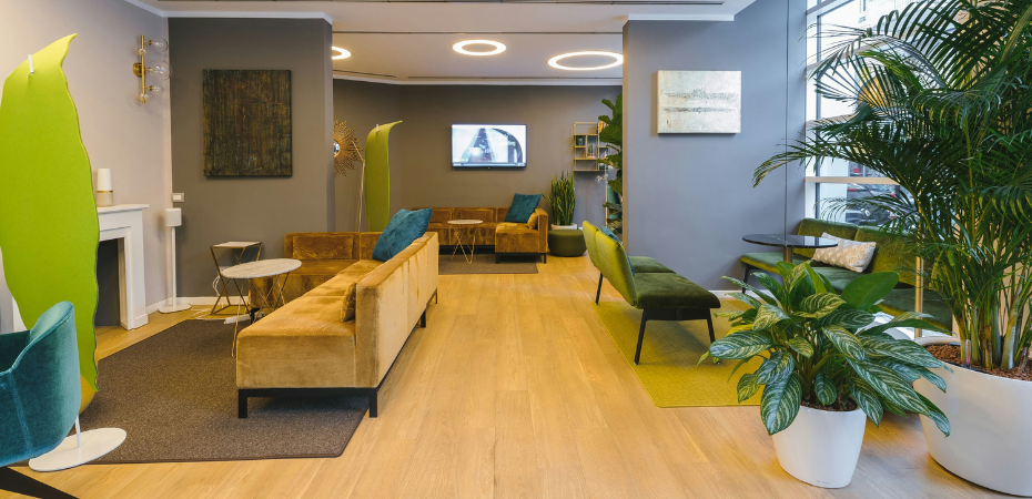 Photograph of an empty office space with modern furniture and lighting.