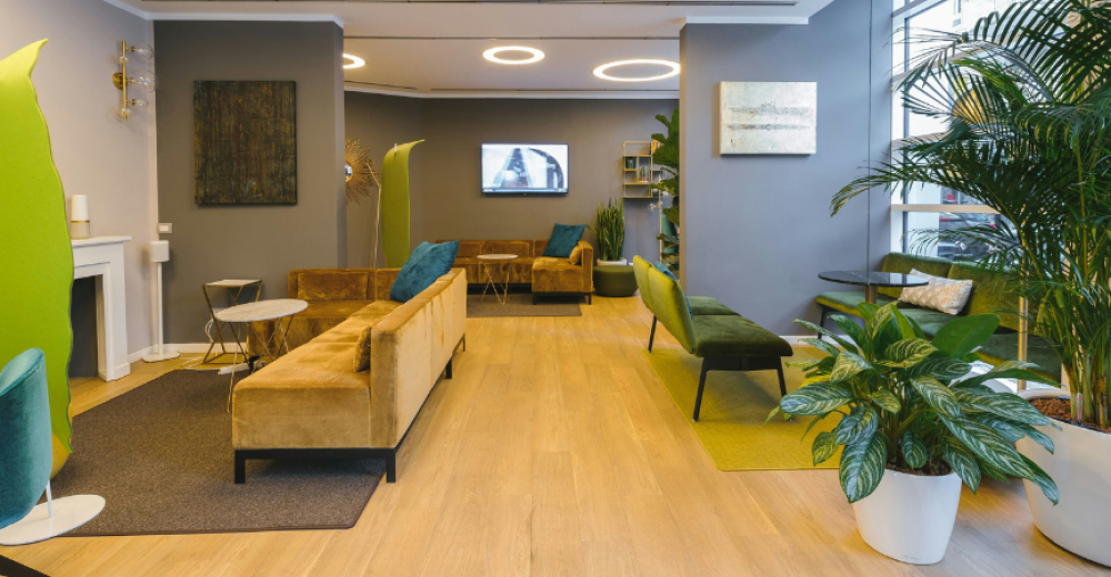 Photograph of an empty office space with modern furniture and lighting.