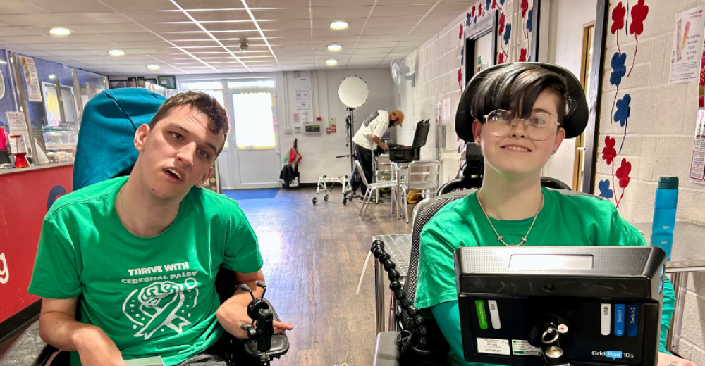 Photograph of volunteers Ryley (left) and Cole (right). They are wearing matching green t-shirts and looking at the camera.