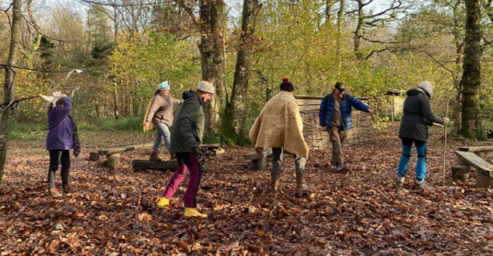 Photograph of a group of people walking though the woodland